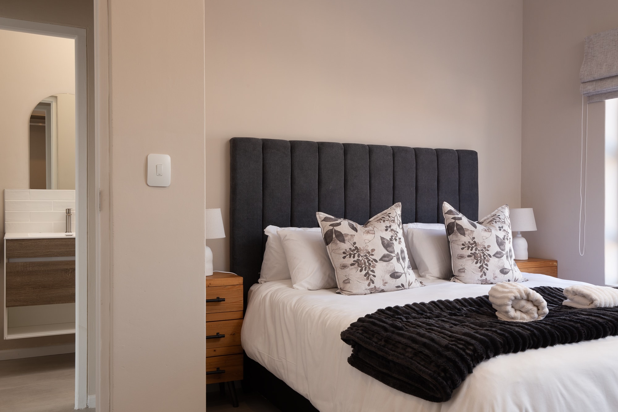 Modern bedroom with black upholstered headboard