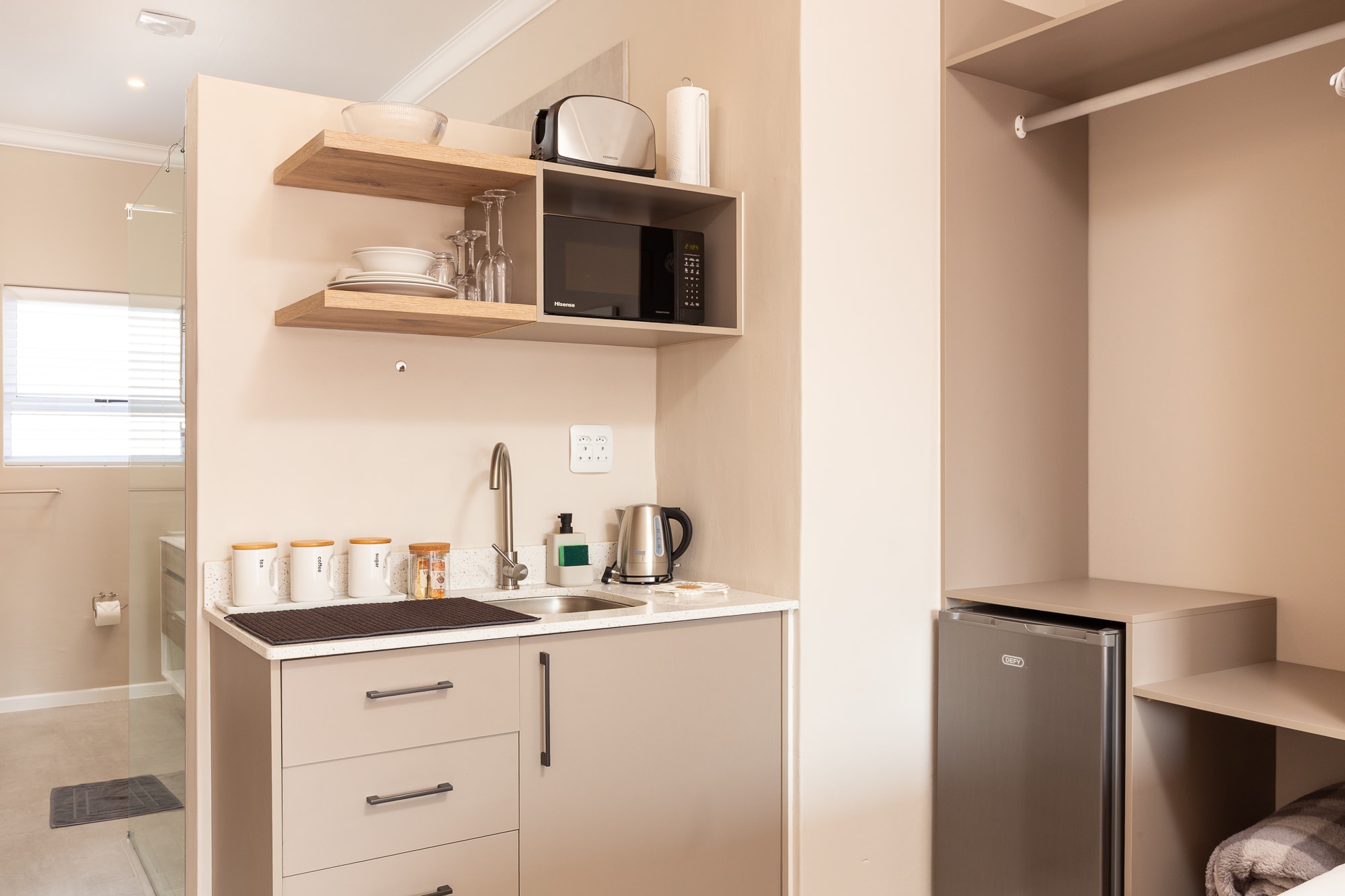 Modern kitchenette with microwave and shelving
