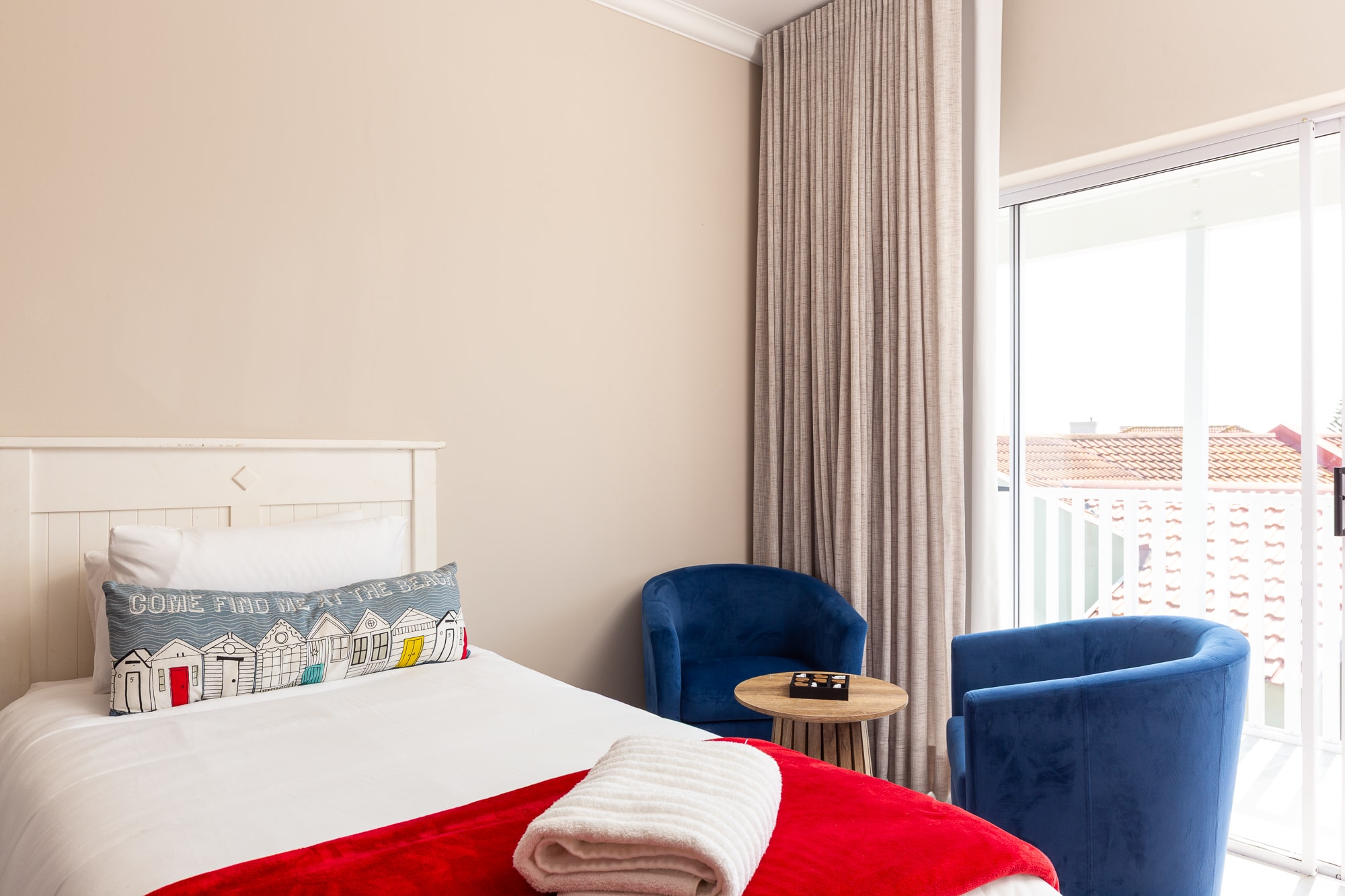 Modern hotel bedroom with blue armchairs