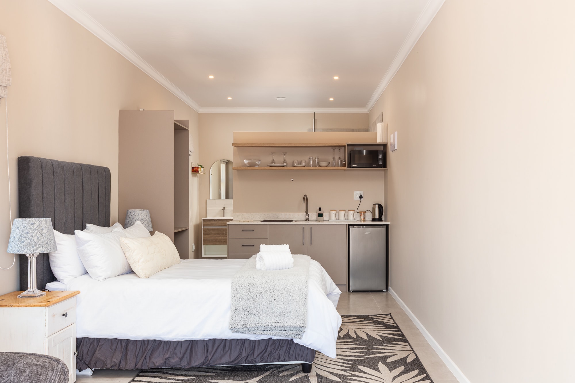 Modern studio apartment bedroom with kitchenette