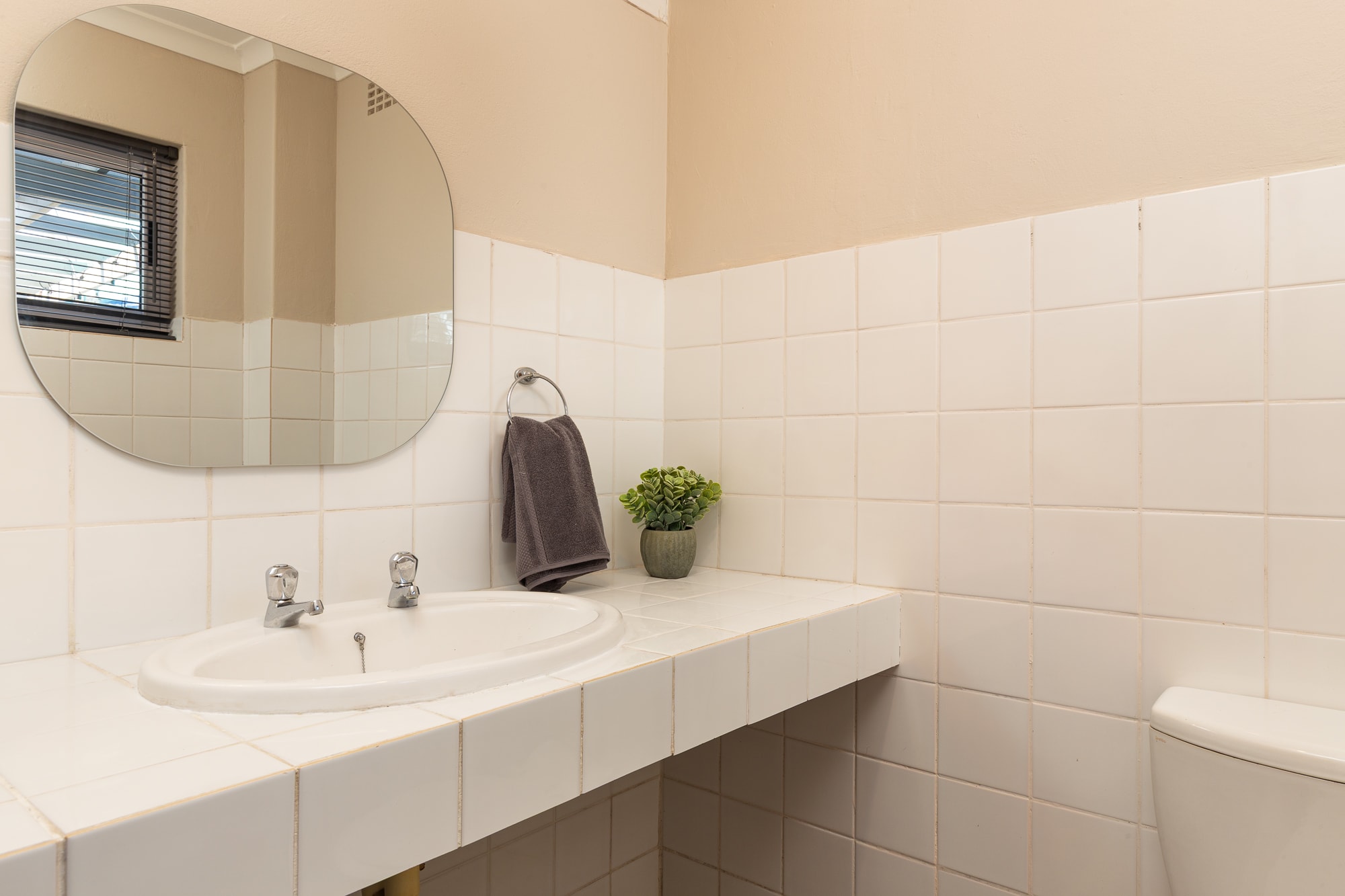 Modern bathroom with white tile and mirror