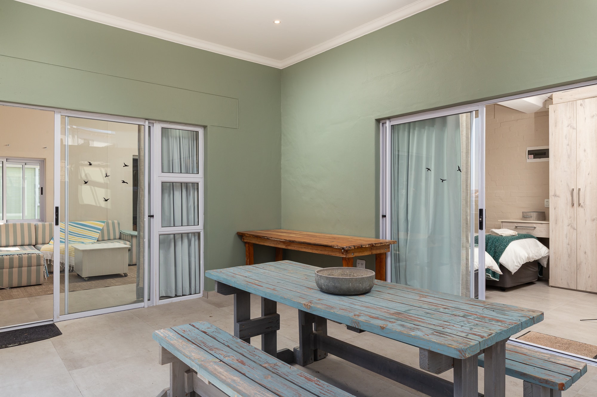 Modern open-plan home with sage green walls