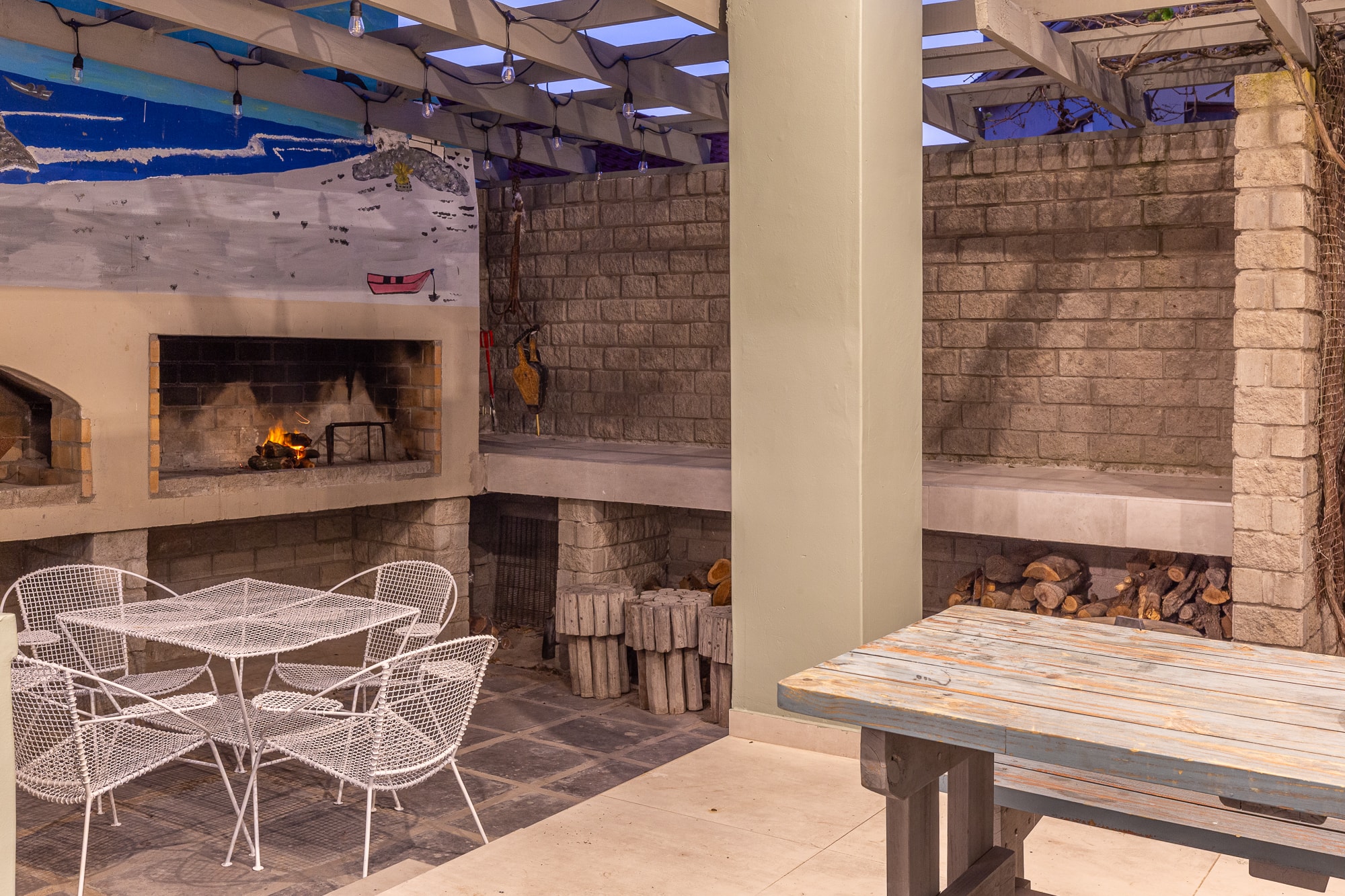 Outdoor patio with fireplace and seating area