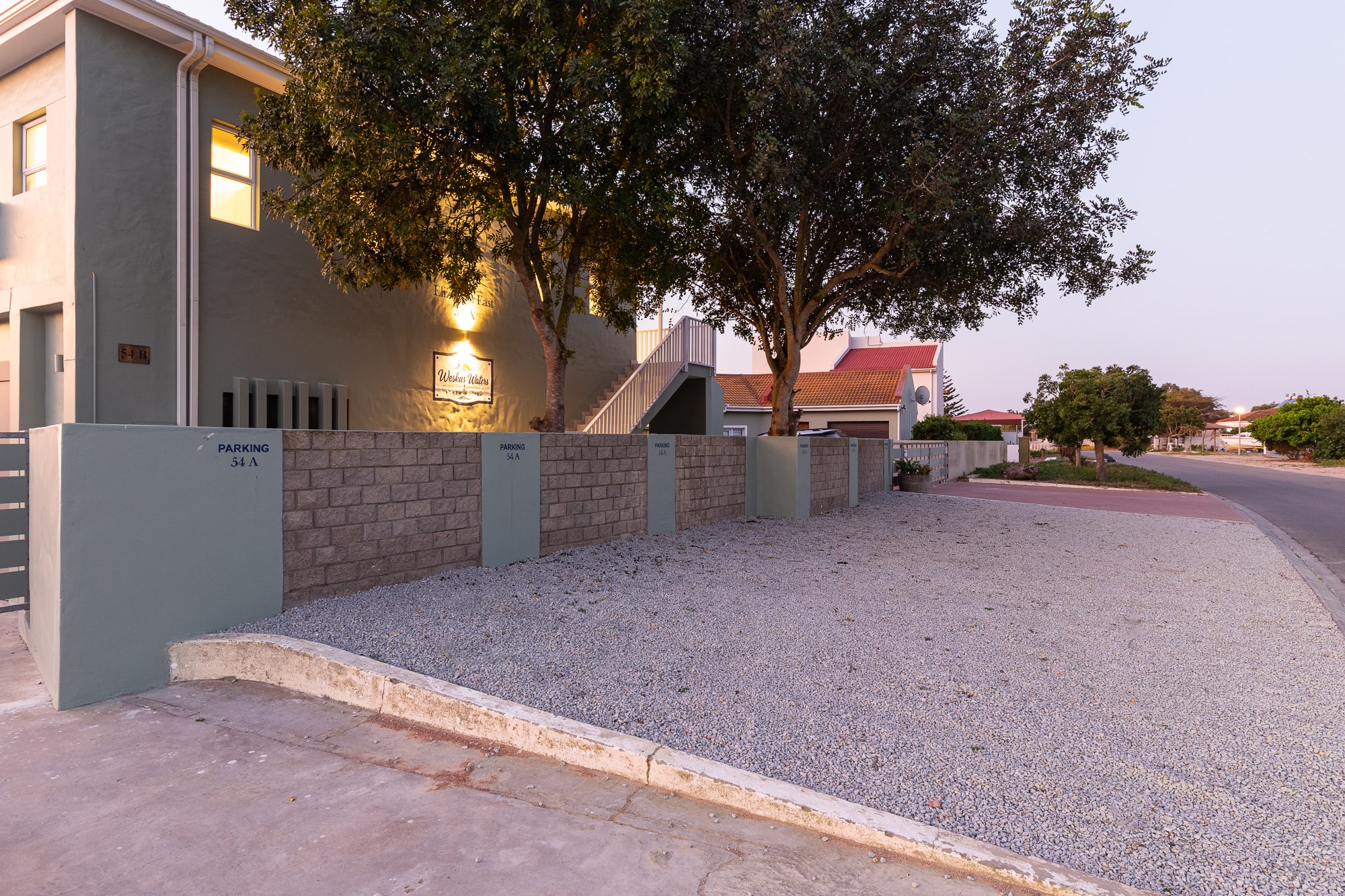 Modern residential street with gated homes at dusk