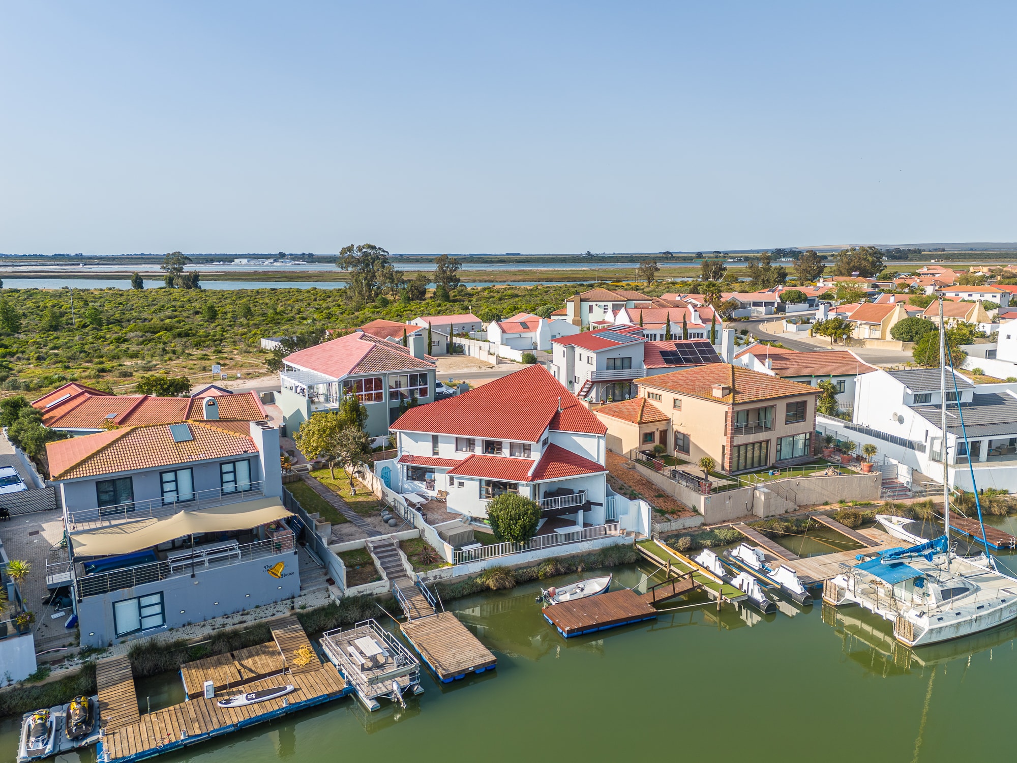 Waterfront village with red-roofed houses and boats